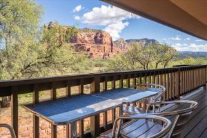 a table and chairs on a balcony with a view at Kaibab - Adobe Village condo - 2 bedroom in Oak Creek