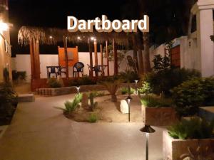 a garden center with a sign that reads dartboard at Posada Nomad in San José del Cabo