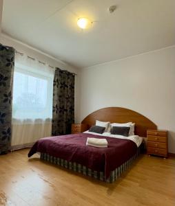 a bedroom with a large bed and a window at Tatari Residence by Rikas Hotels in Tallinn +54 photos