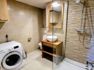 a bathroom with a washing machine and a shower at Appartement moderne 3 pièces aux Arcs 1800 - FR-1-346-537 in Arc 1800 +10 photos