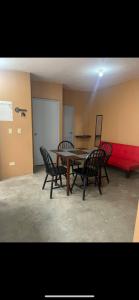 a conference room with a table and chairs and a board at Casa de chapis in Ensenada