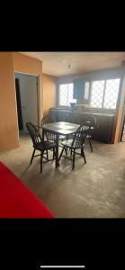 a dining room with a table and four chairs at Casa de chapis in Ensenada +18 photos