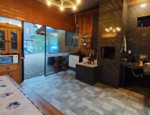 a large kitchen with a counter and a stove at Hospedaje Vildumar in Pichilemu