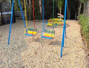 a group of swings on a playground at Hospedaje Vildumar in Pichilemu