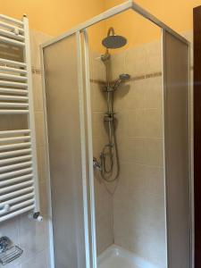 a shower with a clear glass shower stall in a bathroom at La Piccola Stella in Castel del Giudice +6 photos