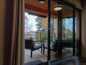 a living room with glass doors and a patio at Chata Budka - parties not allowed in Hradišťko