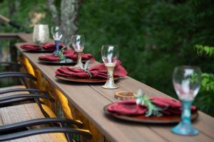 a wooden table with wine glasses and red napkins at "Air Fort One" Aviation-Themed Luxury Treehouse Near Dollywood & Pigeon Forge in Sevierville