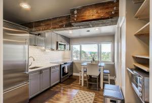 eine Küche mit weißen Schränken und einem Tisch mit Stühlen in der Unterkunft Seattle Luxury Retreat Home Near the Stadiums in Seattle