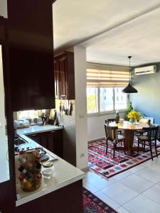 a kitchen with a table and a dining room at Midcentury modern 1 bedroom apartment in Tirana in Tirana