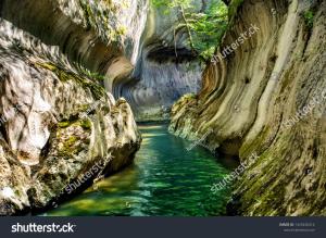 a river in a canyon between two rocks at Cozy Home Studio in Petroşani +4 photos