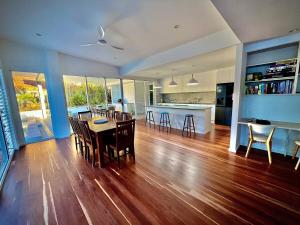 a kitchen and living room with a table and chairs at 3 Moffat Beach Holiday House in Caloundra