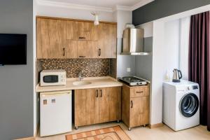 a small kitchen with a sink and a washer and dryer at Luxury and Comfort in Central Alsancak Perfect for Groups or Families in Izmir