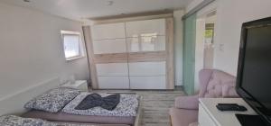 a bedroom with a bed and a door with a bow tie at Sonne in Lünen