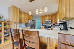 a kitchen with wooden cabinets and a counter with chairs at The Johnson Way in Padgett Mill