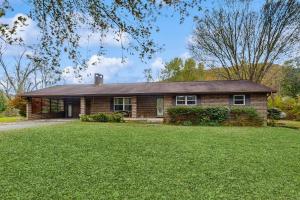 a brick house with a lawn in front of it at The Johnson Way in Padgett Mill