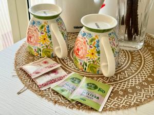 a table with two vases and some packets of toothpaste at Aria di sale B&B in Marina di Strongoli