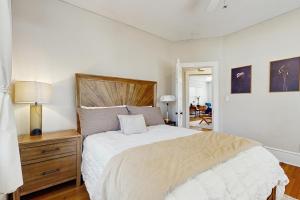 ein Schlafzimmer mit einem großen Bett mit einem hölzernen Kopfteil in der Unterkunft Main Street Brick Cottage in Brevard