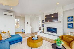 a living room with a blue couch and a fireplace at Pacific Perch in Depoe Bay