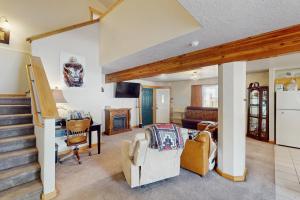a living room with a couch and a table and chairs at Saddle Peak Outpost- Unit A & B in Belgrade