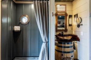 a bathroom with a barrel sink and a mirror at "Land of the Free, Home of the Brave" Double Luxury Treehouse for 12 Near Dollywood & Pigeon Forge in Catlettsburg