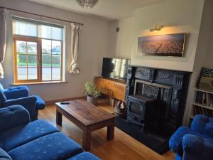a living room with a couch and a fireplace at A spacious home beside the beach in Fethard on Sea