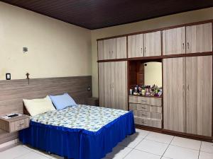 a bedroom with a bed and a dresser with a mirror at Residência COP 30 in Ananindeua