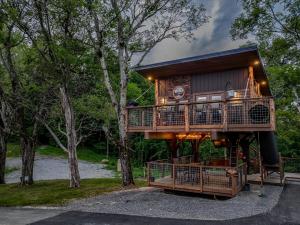 a tree house in the middle of a forest at "Morning Wood" Luxury Treehouse Retreat Near Dollywood & Pigeon Forge in Sevierville