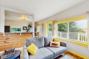 a living room with a couch and a large window at Summit Lookout Bungalow in South Bend