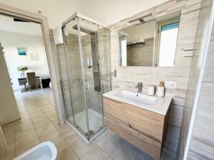 a bathroom with a sink and a shower at Aria di sale B&B in Marina di Strongoli