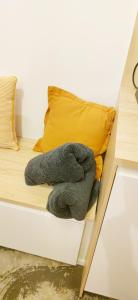 Ein ausgestopftes Tier sitzt auf einem Bett in der Unterkunft Studio bois indépendant aux portes de Nantes in La Chapelle-sur-Erdre