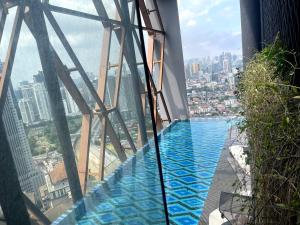 a swimming pool on the top of a building at Scarletz suites klcc Twin Tower by ESD in Kuala Lumpur
