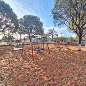 a playground with a swing set in a park at bairro Jardim Parati - casa 2 quartos em condomínio in Campo Grande