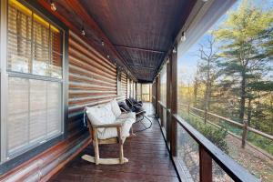 a porch of a house with a couch and windows at Papa's Cabin in Wilmot