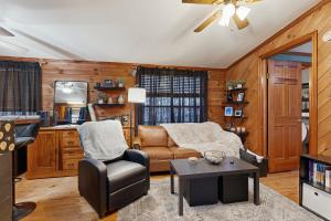 a living room with a couch and a chair at Papa's Cabin in Wilmot