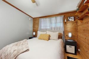 a bedroom with a white bed and a window at Papa's Cabin in Wilmot