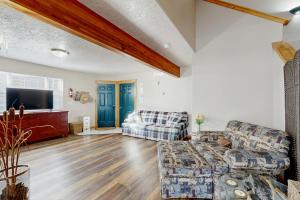 a living room with two couches and a flat screen tv at The Anglers Retreat - Unit A in Belgrade