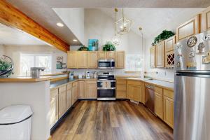 a kitchen with wooden cabinets and stainless steel appliances at The Anglers Retreat - Unit A in Belgrade