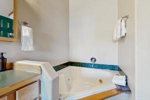 a bathroom with a bath tub and a sink at The Anglers Retreat - Unit A in Belgrade +17 photos