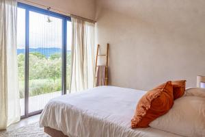 a bedroom with a bed and a large window at Casa Oasis in San Luis