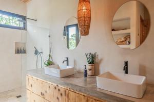 a bathroom with two sinks and a mirror at Casa Oasis in San Luis +42 photos