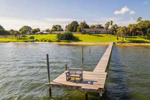 a bench sitting on a dock on a lake at The Sound at Seaglade in Seaglades