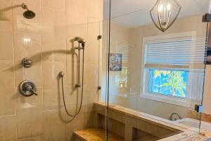 a bathroom with a shower with a glass door at The Sound at Seaglade in Seaglades +9 photos