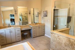 a large bathroom with two sinks and a shower at The Sound at Seaglade in Seaglades