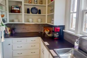 a kitchen with a sink and a counter top at The Jul on State in Bremerton