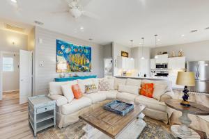 a living room with a white couch and a table at Gulf Breeze in Rockport