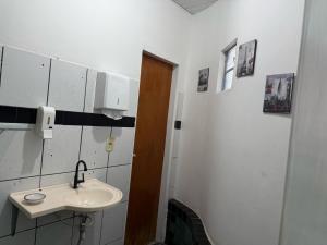 a bathroom with a sink and a toilet at Quartos compartilhados COP30 - BRL in Belém +7 photos