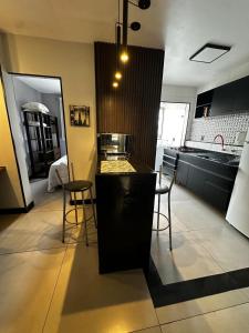 a kitchen with a counter and some chairs in a room at Modern Apartment in São Caetano do Sul in São Caetano do Sul