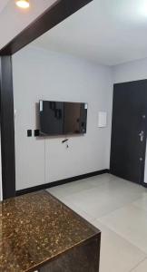a room with a tv on a white wall at Modern Apartment in São Caetano do Sul in São Caetano do Sul +14 photos