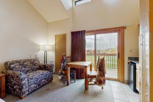 a living room with a couch and a table and a window at Dells Den Condo #7306 in Wisconsin Dells