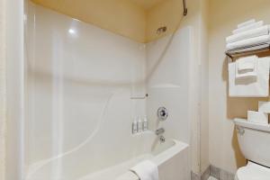a bathroom with a white tub and a toilet at Dells Den Condo #7306 in Wisconsin Dells +18 photos